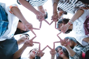 99+ Smooth Rizz Lines That Actually Work in 2025 2 Friends stand in a circle and hold up peace signs - Stock image