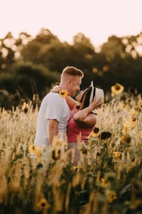 99+ Smooth Rizz Lines That Actually Work in 2025 1 Two couples standing on lush sunflower fields, laughing in a cheerful mood. - Stock image